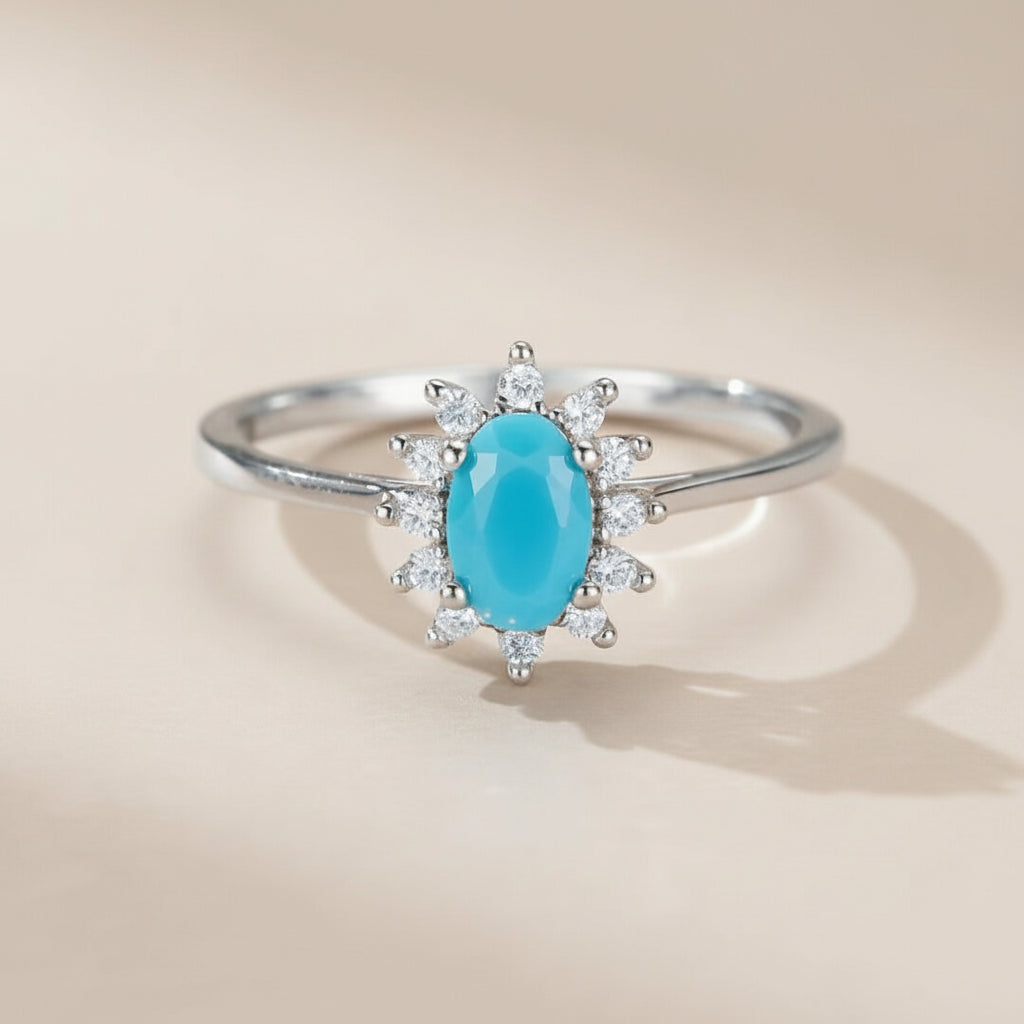 Bague en argent 925 avec une turquoise ovale bleue et un halo de zirconium, style fleur marine.