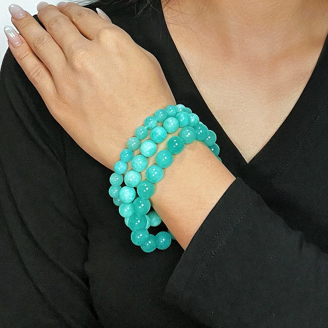 Bracelet Amazonite "Fraîcheur Douce" composé de trois rangs de perles rondes bleues turquoise porté au poignet d'une femme