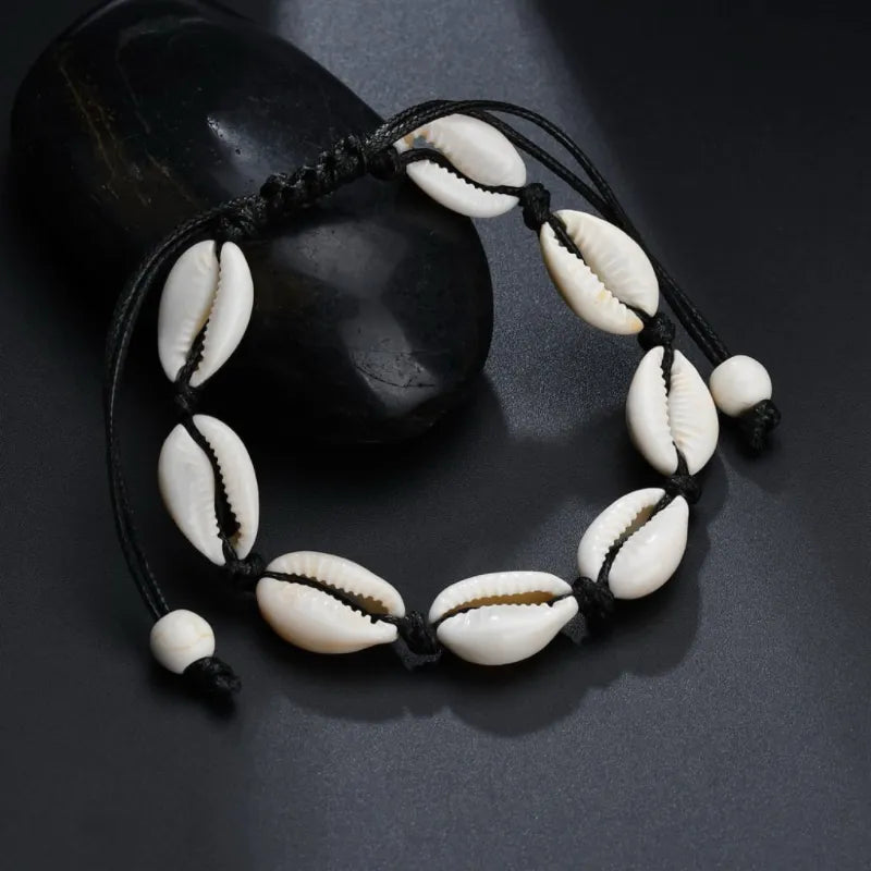 Bracelet de cheville "Douceur Océan" orné de coquillages cauris naturels sur cordon noir ajustable, style bohème.