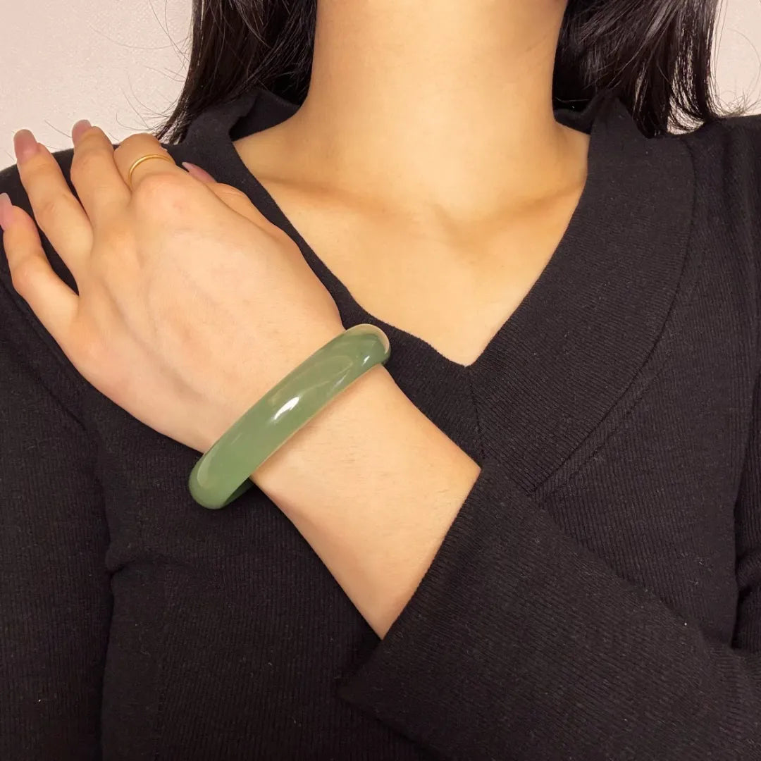 Bracelet jonc en aventurine "Énergie Vitale" vert pâle porté au poignet d'une femme.