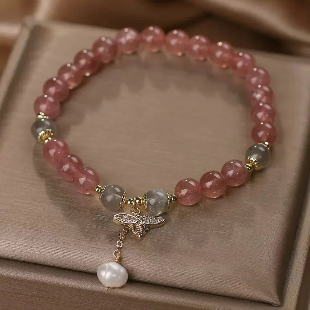 Bracelet "Douceur Abeille" en quartz fraise et labradorite, orné d'un pendentif abeille en zirconium et d'une perle blanche.