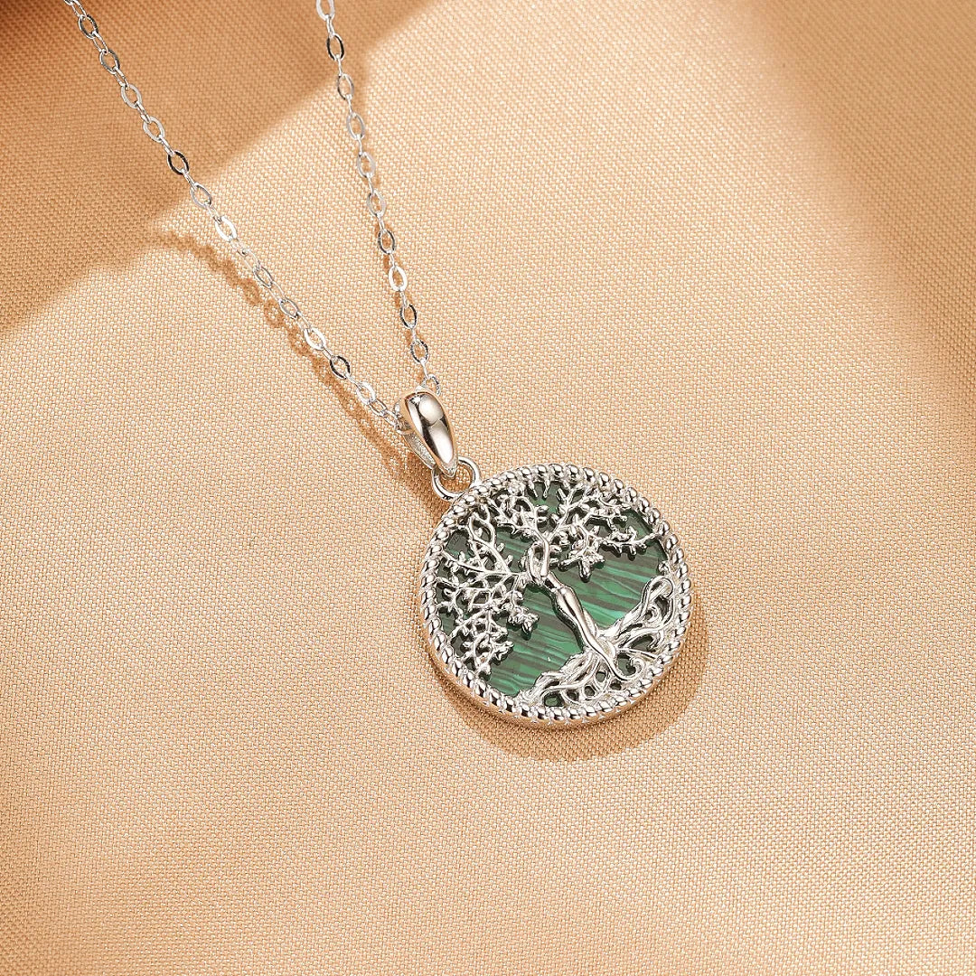 Collier Arbre de Vie avec un pendentif rond en argent orné d'une malachite verte striée, représentant un arbre aux racines profondes et une chaîne en argent.