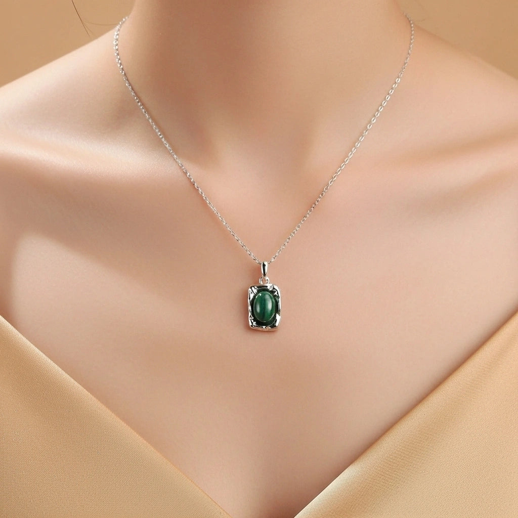 Collier "Élégance Intemporelle" en argent avec un pendentif rectangulaire orné d'une pierre de malachite verte ovale.