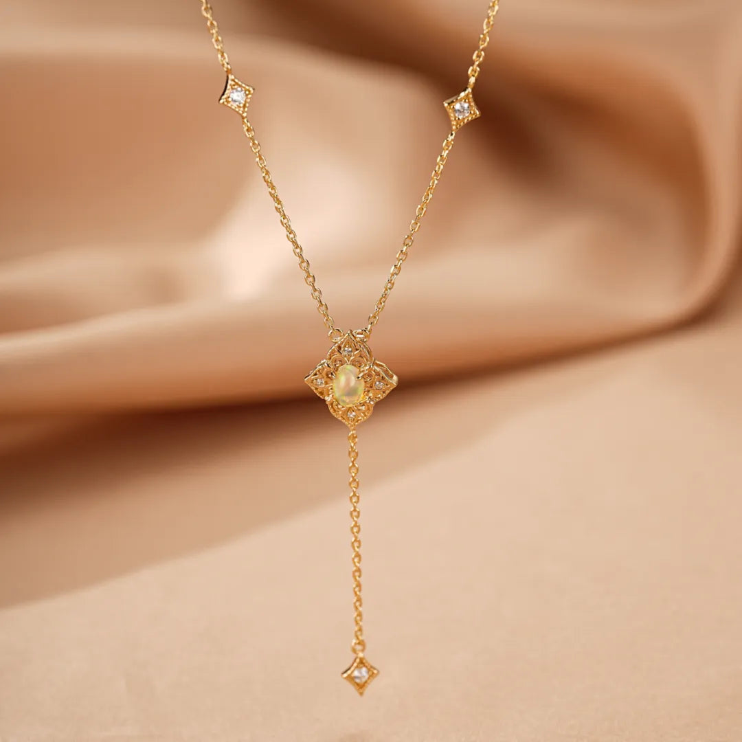 Collier Opale Lumière Antique en argent doré à l'or, avec un pendentif en forme de quadrifoglio orné d'une opale et de petits diamants, et une chaînette tombante avec un diamant carré.