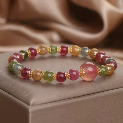 Bracelet "Lumière Colorée" fait de tourmalines et de quartz fraise aux couleurs vives, avec une grosse perle rose au centre.