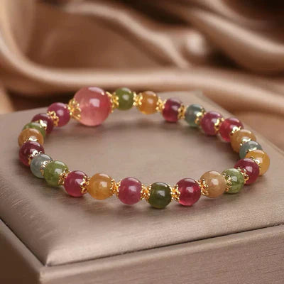 Bracelet "Lumière Colorée" en tourmaline et quartz fraise avec des perles multicolores et des séparateurs dorés.